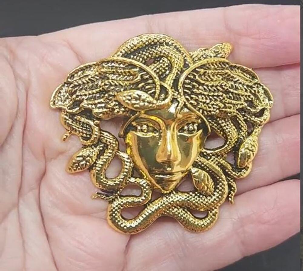 Medusa Brooch Gold Tone Metal Accented with Black for an Old-Fashioned Look